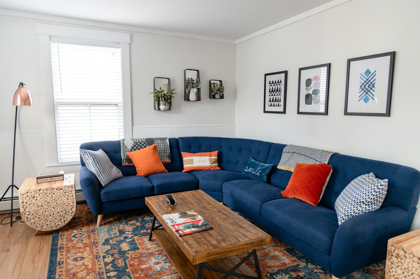 Living room with blue sofa and orange cushions